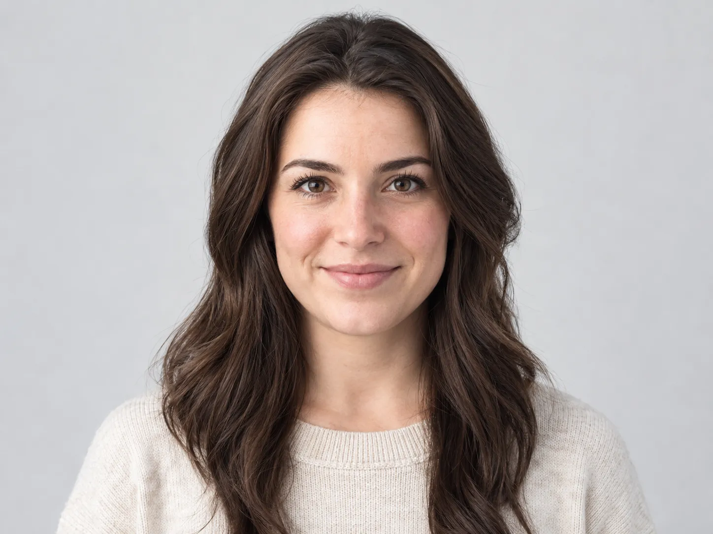 Clean studio headshot against a plain light grey wall