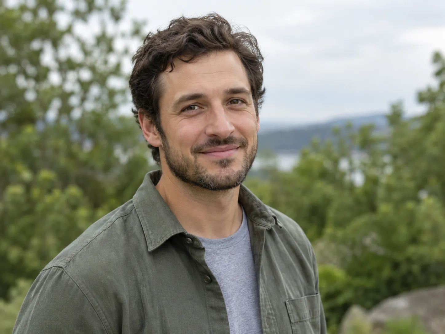 Casual profile portrait outdoors with blurred greenery