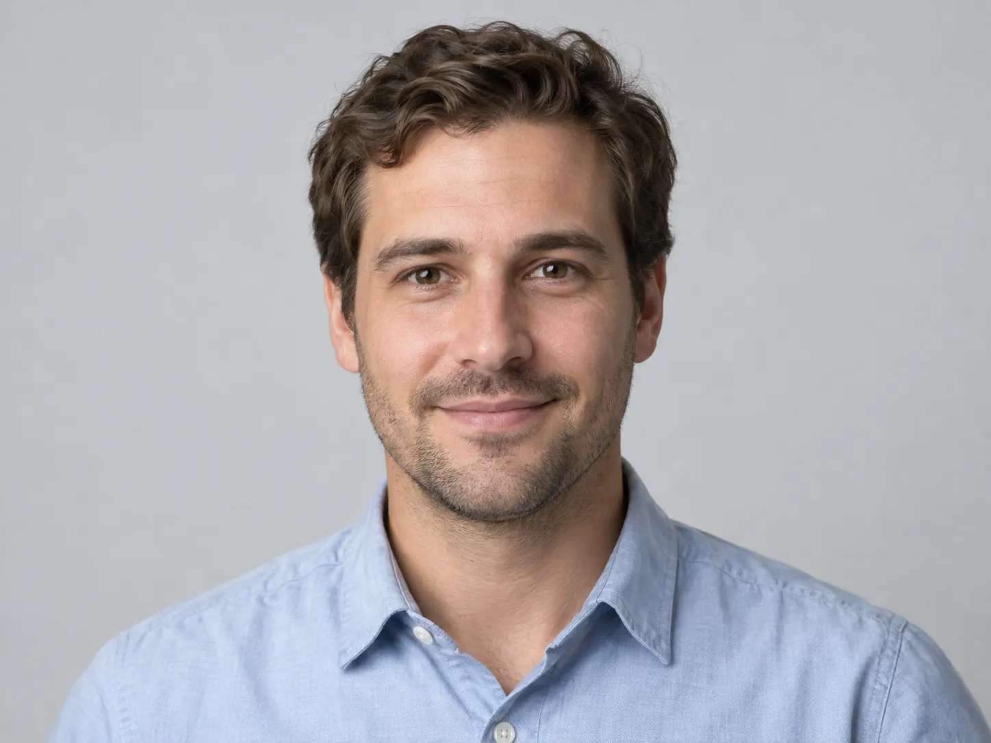 Clean professional profile picture on a light grey background