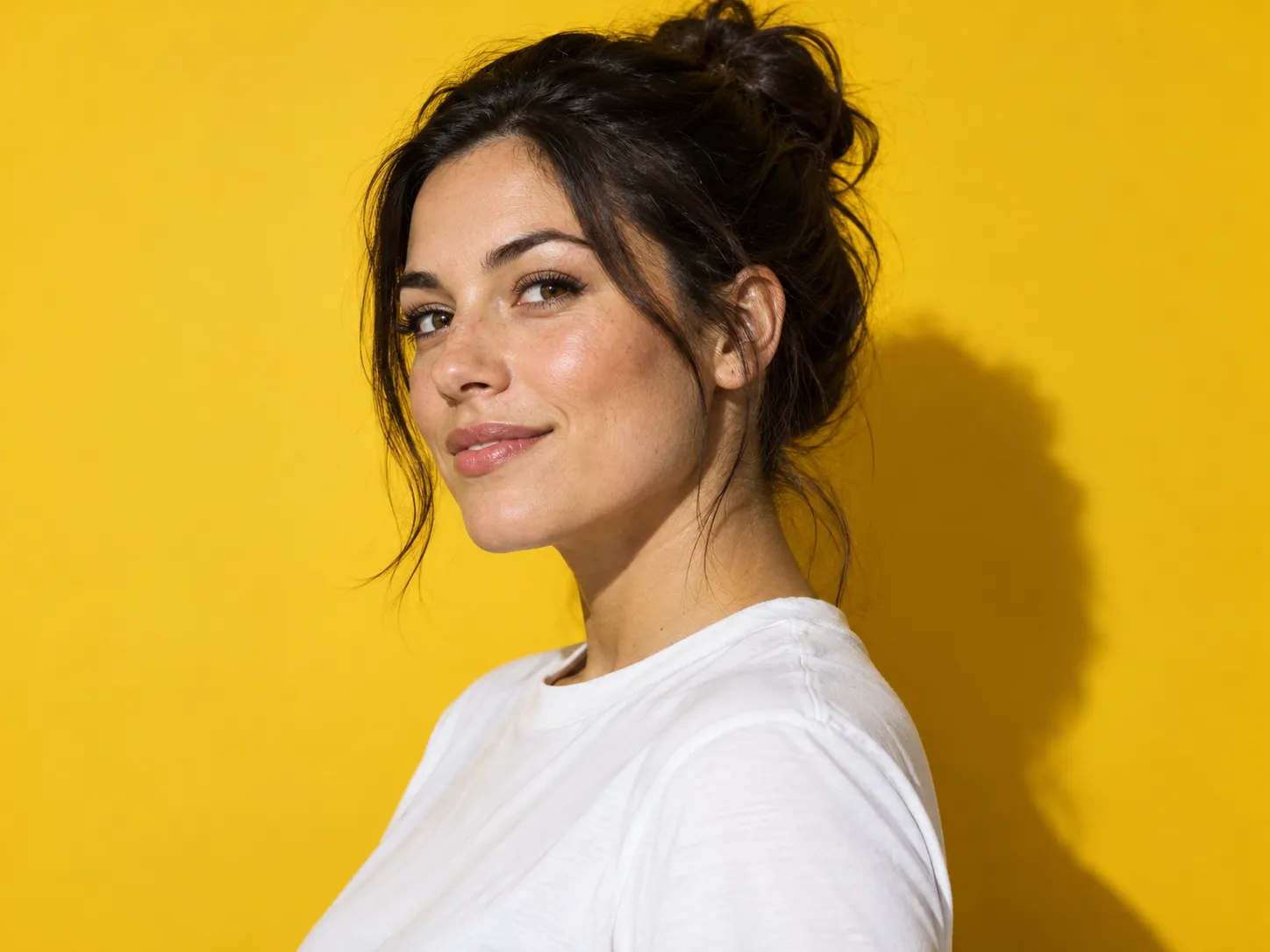 Colorful studio profile photo against a mustard backdrop
