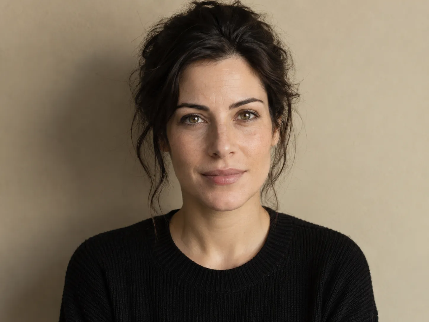 Minimalist profile photo against a warm beige wall