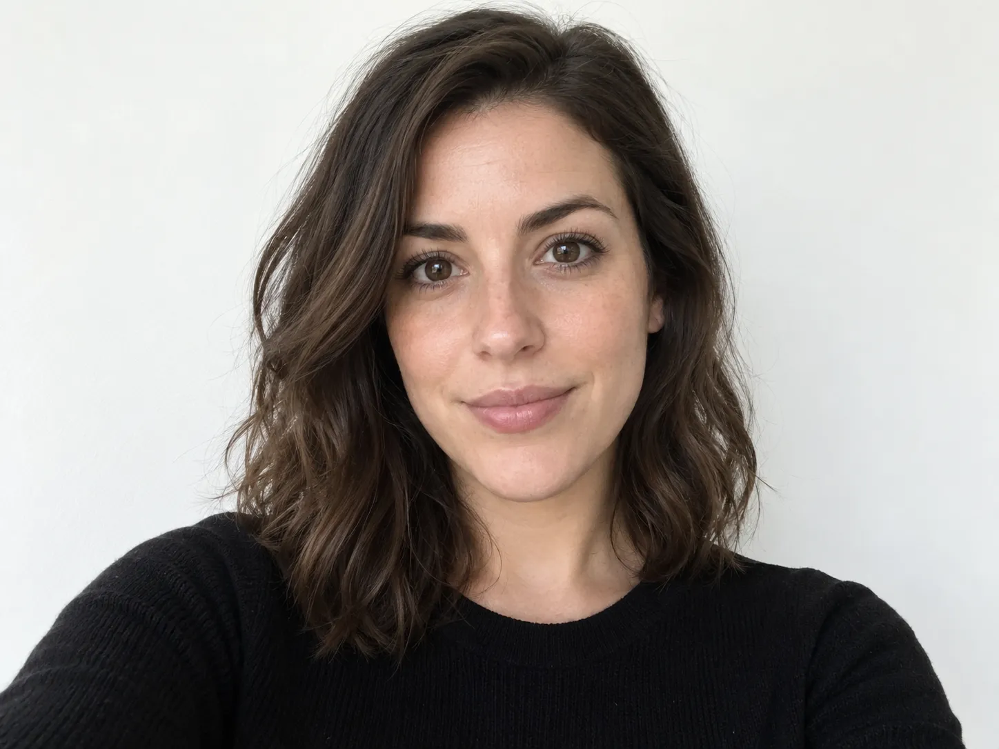 Minimal selfie against a flat white wall