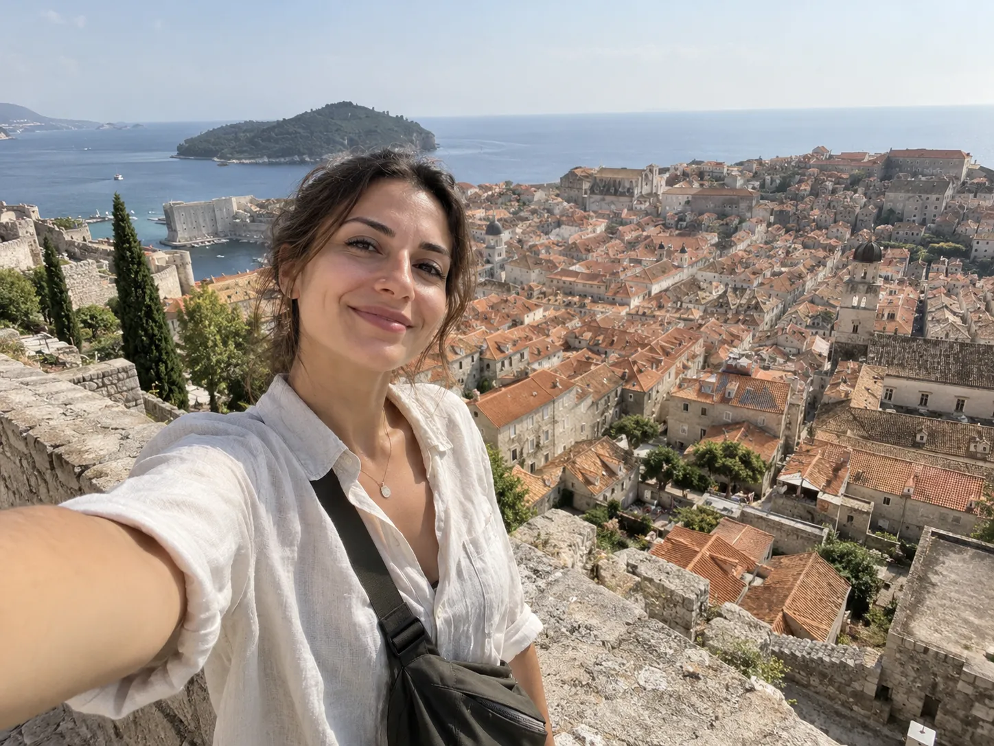 Travel selfie overlooking an old town from a viewpoint